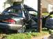 1999 Ford Crown Victoria - This black sedan sustained severe damage to its roof and side after colliding with a utility pole.