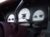 Close-up of three white-faced car gauges, likely from the dashboard