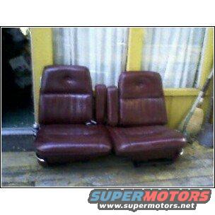 pair of maroon car seats with center console