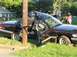 1999 Ford Crown Victoria - A severely damaged sedan is wrapped around a utility pole after an accident.