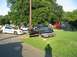 1999 Ford Crown Victoria - A black sedan is heavily damaged after crashing onto a grassy area, with its doors ajar.