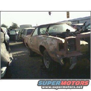 1973 Ford Ranchero in junkyard, heavily rusted, hood open, front end damaged