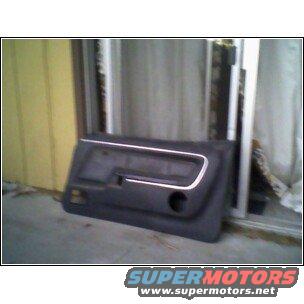 Black car door panel with chrome trim and a speaker cutout
