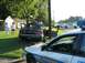 1999 Ford Crown Victoria - A damaged sedan is attended to by police after an apparent accident, with onlookers present.