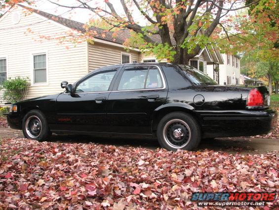 Black 2000 Ford Crown Victoria sedan, side view