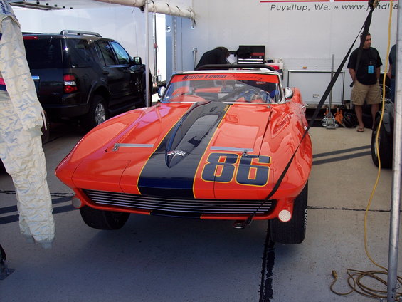 Orange and blue race car with number 86 on hood