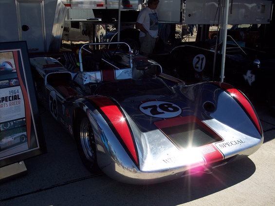 Race car with number 76 on hood, red stripes, and 'SPECIAL' on front. Another car with number 21 visible behind it