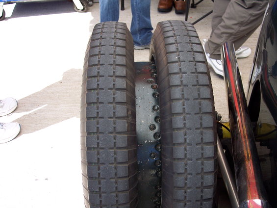 Dual rear tires on a vehicle with visible exhaust pipes