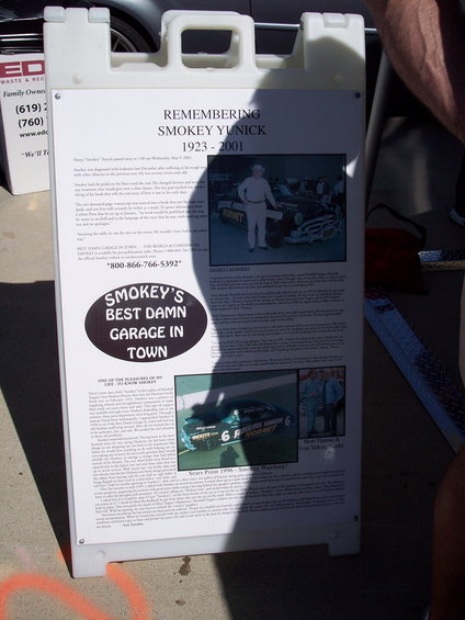 Display board remembering Smokey Yunick, with photos of race cars and people