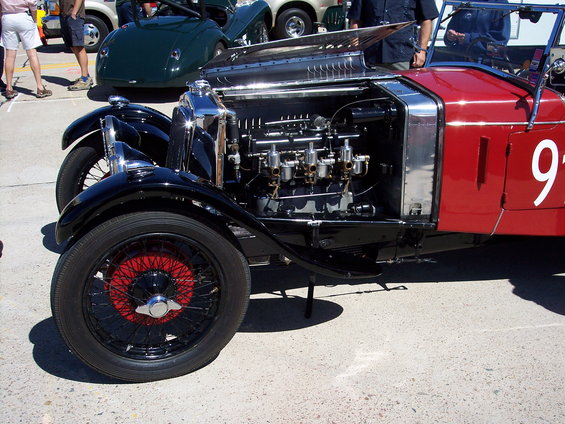Red race car with exposed engine and white number 9 on door