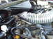 1992 Ford Crown Victoria - Close-up view of an engine bay, focusing on the cold air intake system and throttle body.