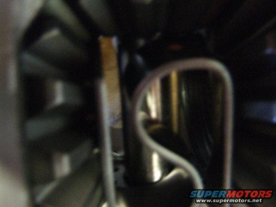 Close-up of a car's interior trim piece with a white wire running nearby