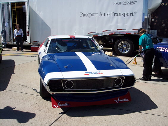Front view of a blue and white race car with red stripes and 'Javelin' on the front splitter