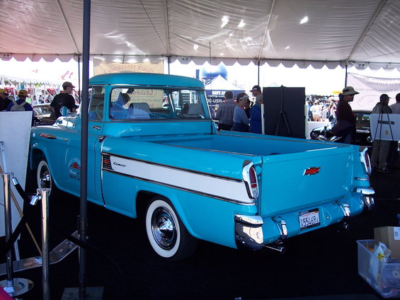 Blue 1955 Chevrolet pickup truck, rear view, with white side stripe and chrome bumpers