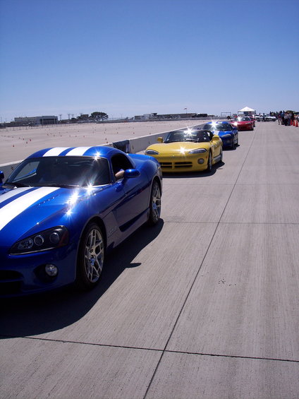 Blue Dodge Viper with white stripes in a line of sports cars