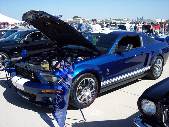Blue 2007 Ford Mustang GT500KR with hood open, white racing stripes, and chrome wheels