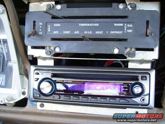 Aftermarket Kenwood stereo installed below original climate controls in a vehicle interior