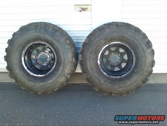 Two large off-road tires on black rims