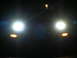 2007 Mazda 3 - Front view of a car's headlights and turn signals on at night.