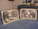 2007 Mazda 3 - A pair of aftermarket headlights are displayed on a bedspread.