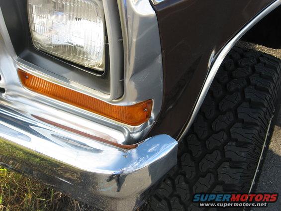 Brown 1978 Ford Bronco front corner with chrome bumper, orange turn signal, and large tire
