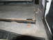 1995 Ford C-350 (Centurion Conversions) - The interior of a vehicle shows a section of carpeted flooring with a metal seat frame and a folded seat base.