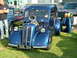 1988 Ford Sport - Customized blue hot rod with a prominent engine and unique grille, parked outdoors with other vehicles.