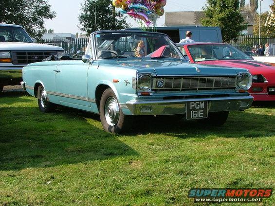 Light blue convertible with a chrome grille and a black license plate reading PGW 161E