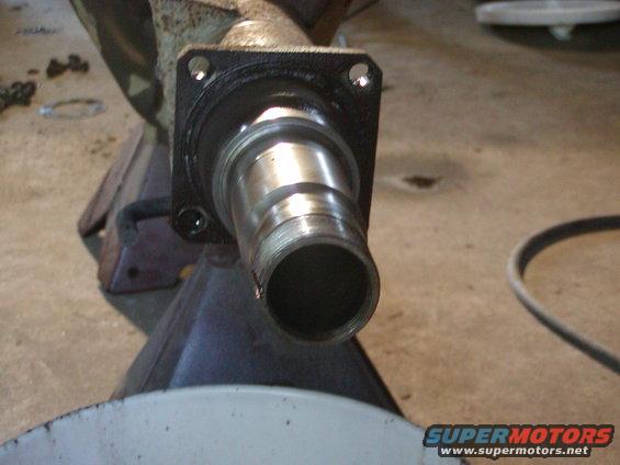 Close-up of a metal axle component on a jack stand