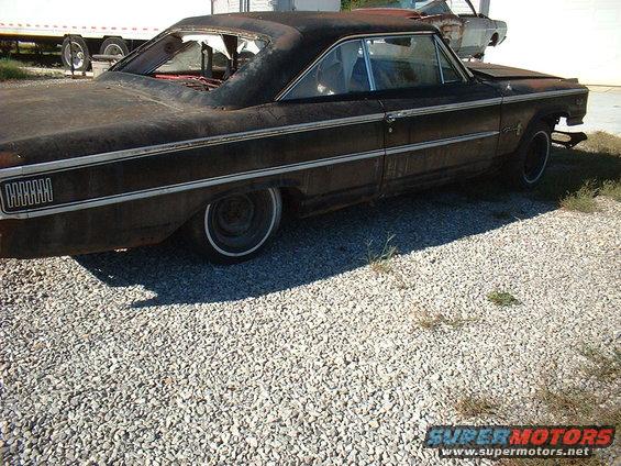 1963 Ford Galaxie 500, rusty, parked on gravel with another car in background