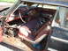 1963 Ford Galaxie - The interior of this old car is filled with debris and parts, showing significant wear and tear.