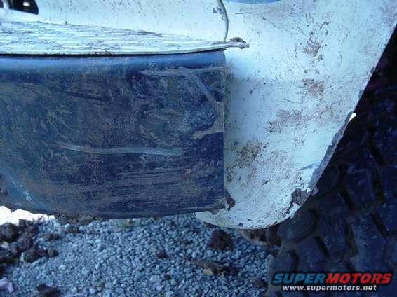 Mud splattered on a vehicle's fender and tire