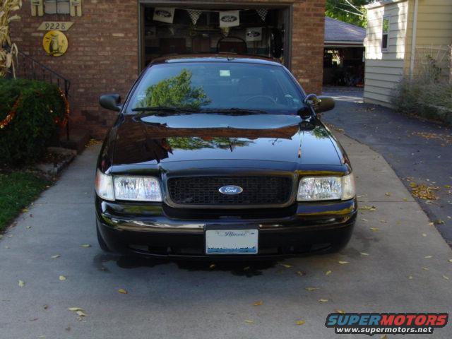 Black 2003 Ford Crown Victoria parked in driveway, front view