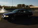 2003 Ford Crown Victoria - Black 2003 Ford Crown Victoria parked near a fountain and football field.