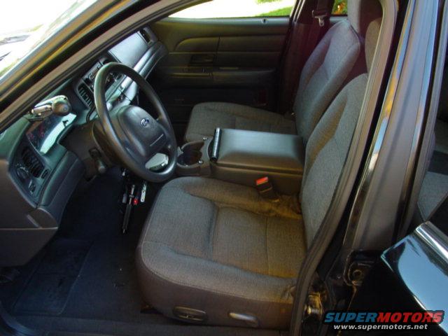 Interior view of a 2003 Ford Crown Victoria showing front seats and dashboard