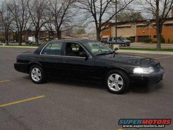 Black 2003 Ford Crown Victoria with LX Sport rims parked in a lot