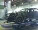 2003 Ford Crown Victoria - A black 2003 Ford Crown Victoria is shown on a repair lift with its front end disassembled.