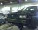 2003 Ford Crown Victoria - Front view of a 2003 Ford Crown Victoria undergoing repairs in a workshop.