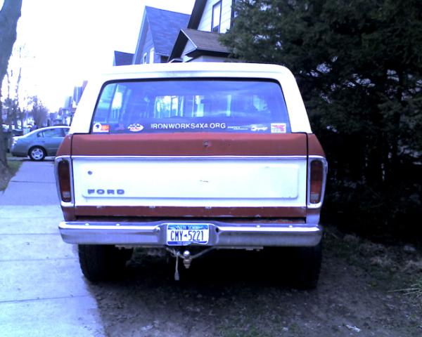 1978 Ford Bronco rear view, two-tone red and white, with a New York license plate CMY-5221