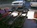 1964 Ford Ranchero - Custom chassis project in progress, with a white SUV and a pickup truck visible in the background.