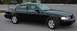 2003 Ford Crown Victoria - A black 2003 Ford Crown Victoria sedan is parked on asphalt, viewed from the front three-quarter angle.