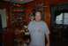 1996 Ford Bronco - A man stands in a room filled with model cars and memorabilia.