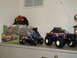 1979 Ford Bronco - A collection of model car boxes and remote control monster trucks are displayed on a shelf.