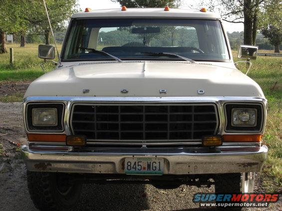 White Ford truck front view, chrome grille, orange turn signals, license plate 845-WG1