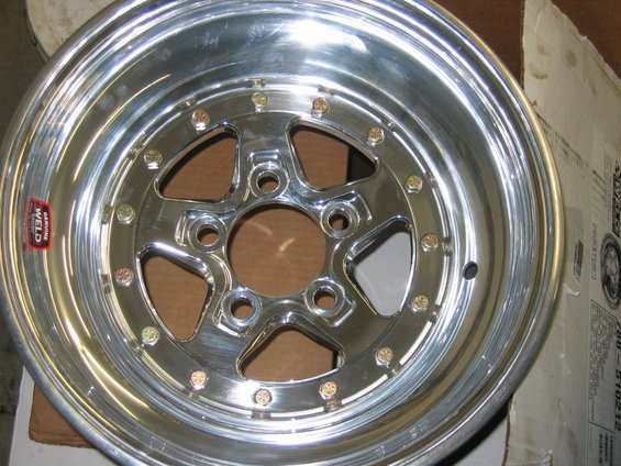 Chrome Weld wheel with five spokes and gold lug nuts, a red 'Genuine Weld' sticker is visible