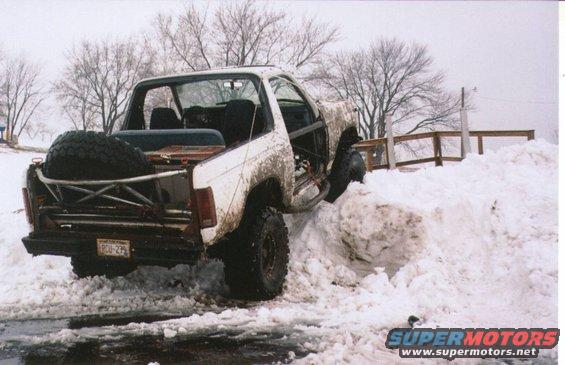 snowpilestuck1.jpg The Bronco has been stabled too long...so I hit the snow piles across the lake from my house.  AND HIGH CENTERED!
