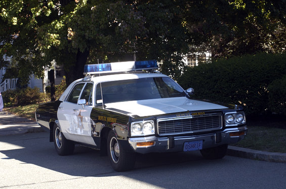 1973 police car with light bar and "Deputy Sheriff" text