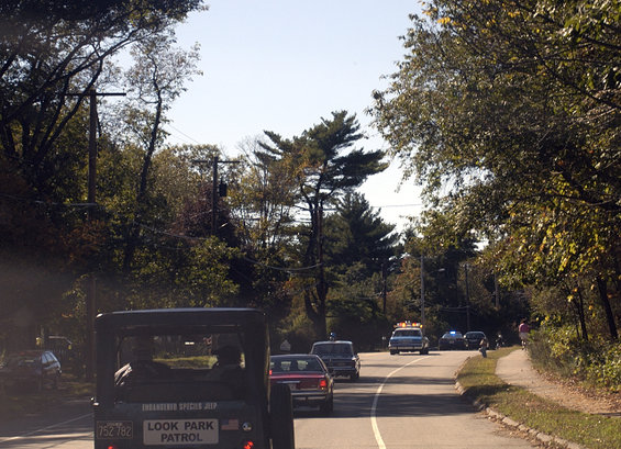 Rear view of a dark green vintage jeep with 'LOOK PARK PATROL' text and license plate 752 782