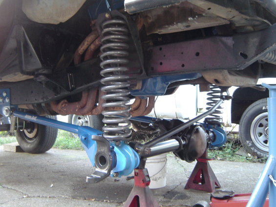 1978 Ford Bronco front suspension with blue lift components and large coil springs