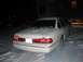 1996 Ford Crown Victoria - A white Ford Crown Victoria is parked in the snow at night, with tire tracks visible.